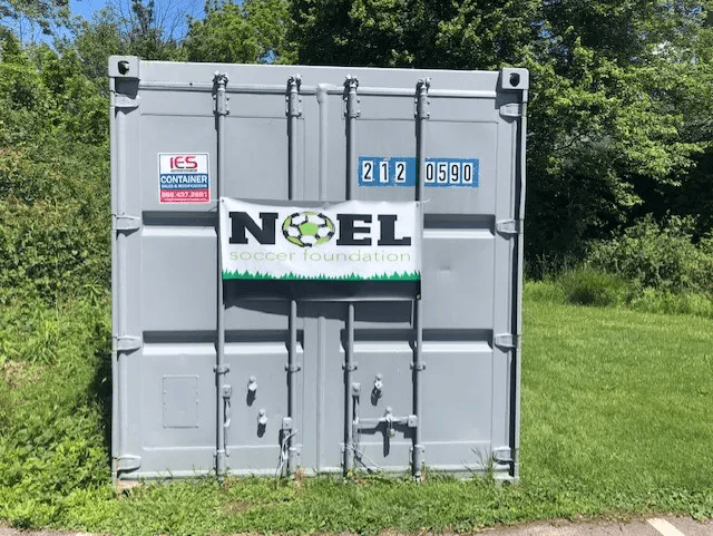 Storage container with a Noel Soccer Foundation banner, donated to Ardsley North Hills Athletic Association