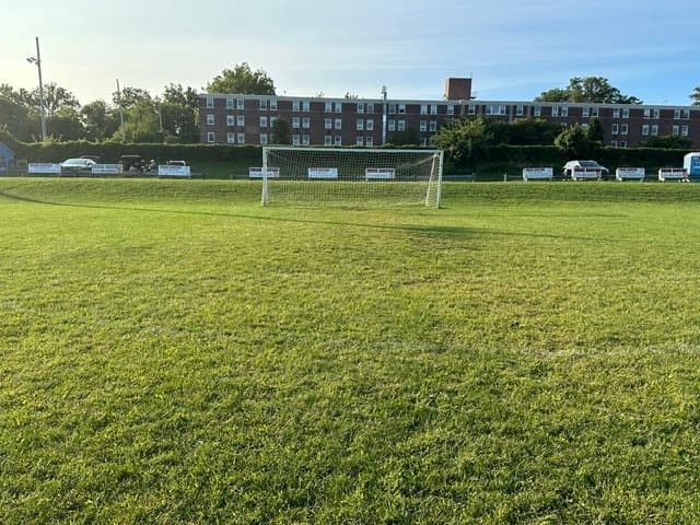 Restored Lighthouse Soccer Club field with goals and bleachers